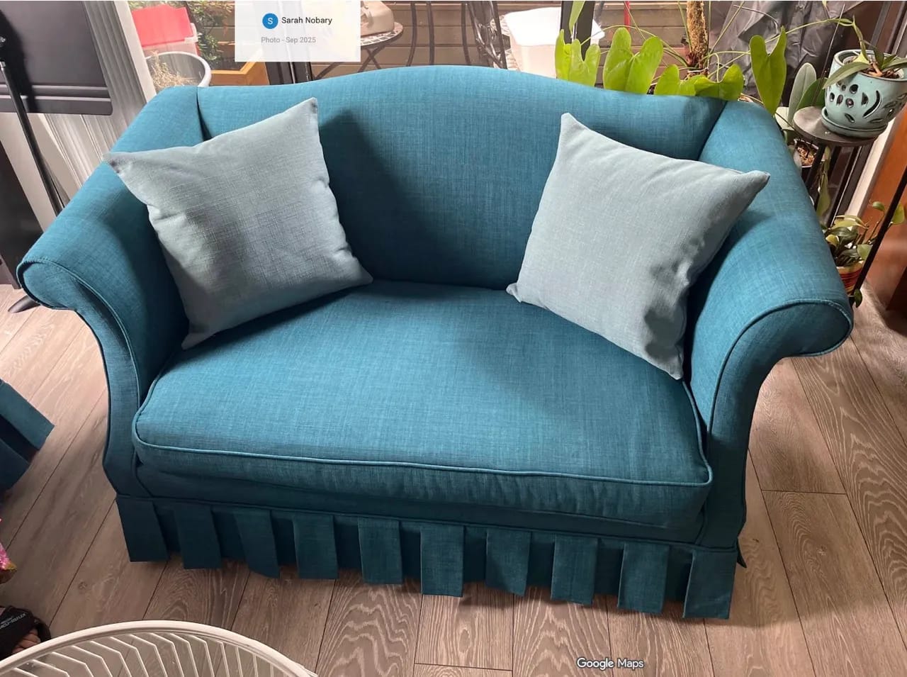 Reupholstered sectional sofa with neutral fabric and accent pillows in living room